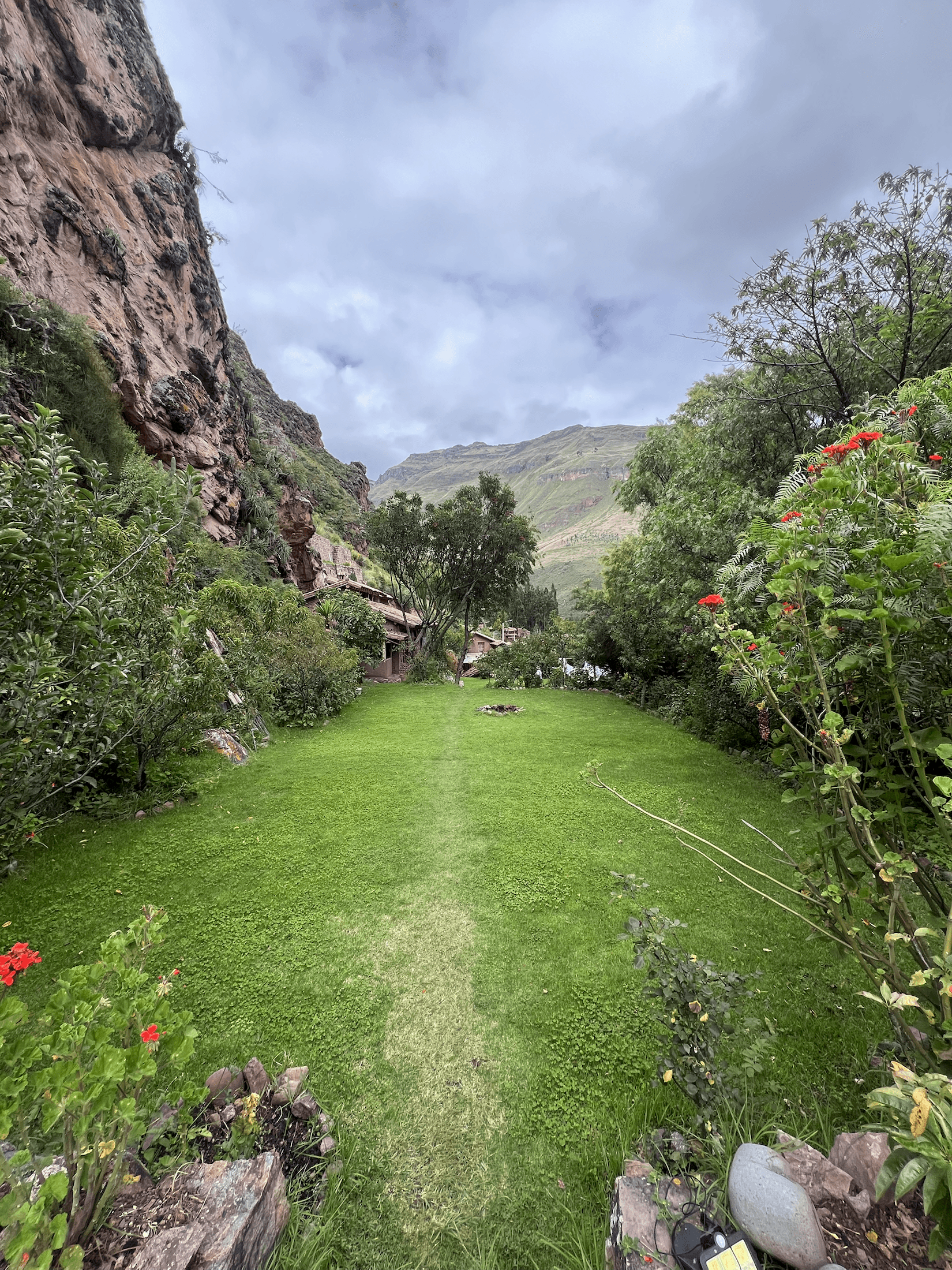 Open lawn at El Molle framed by rock walls and valley greenery